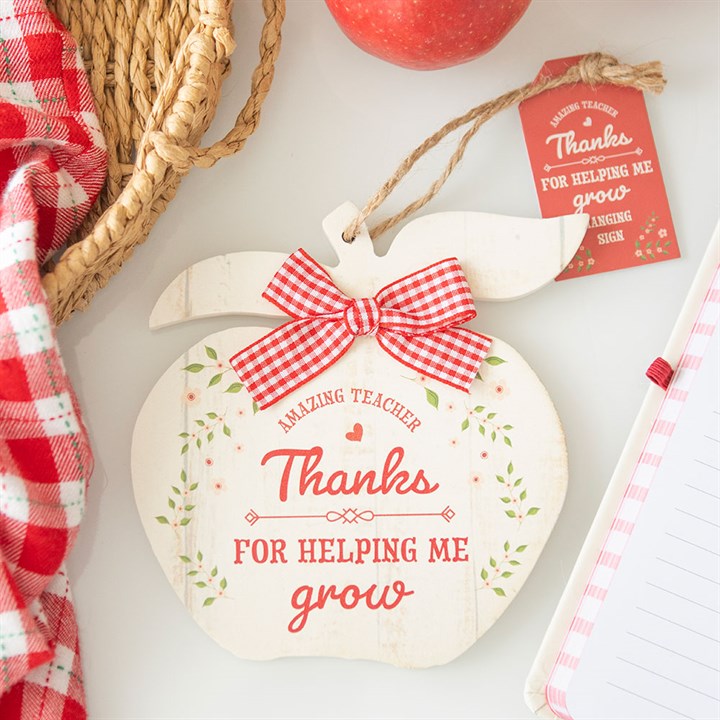 Heart-shaped wooden ornament with a red checkered bow, 'Thanks for helping me grow' text, on a light background.