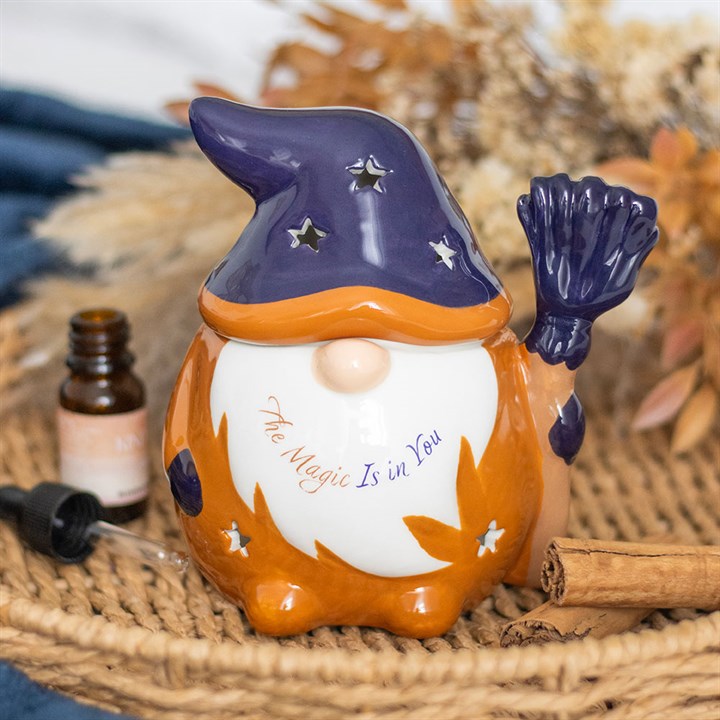 Decorative gnome with purple hat and 'The Magic Is in You' text on a woven surface.