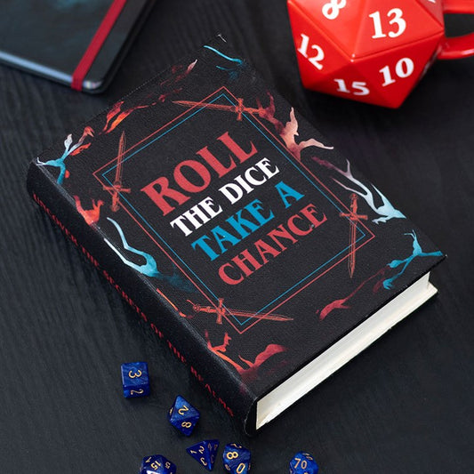 Book titled 'Roll the Dice, Take a Chance' with dice and a red die on a dark surface