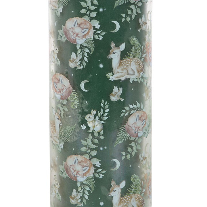 Candle with deer and floral design on a green background
