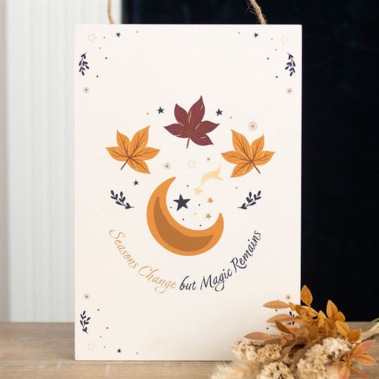 Card with autumn leaves and a moon design on a white background
