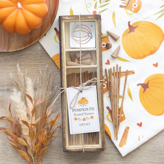 Pumpkin pie scented incense set with decorative elements on a wooden surface