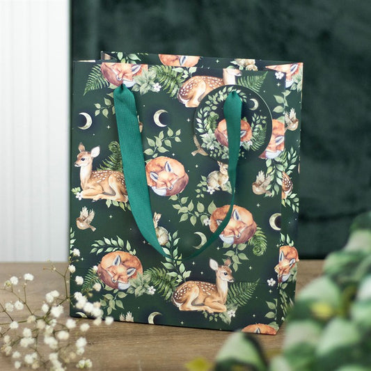 Gift bag with forest animal pattern on a wooden surface